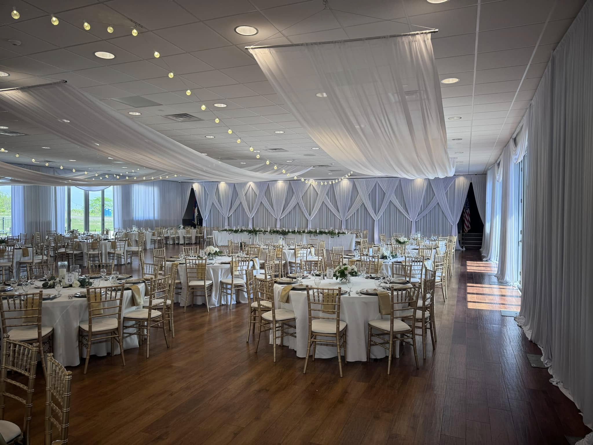 St. Sava reception with dramatic draped backdrop and hardwood dance floor