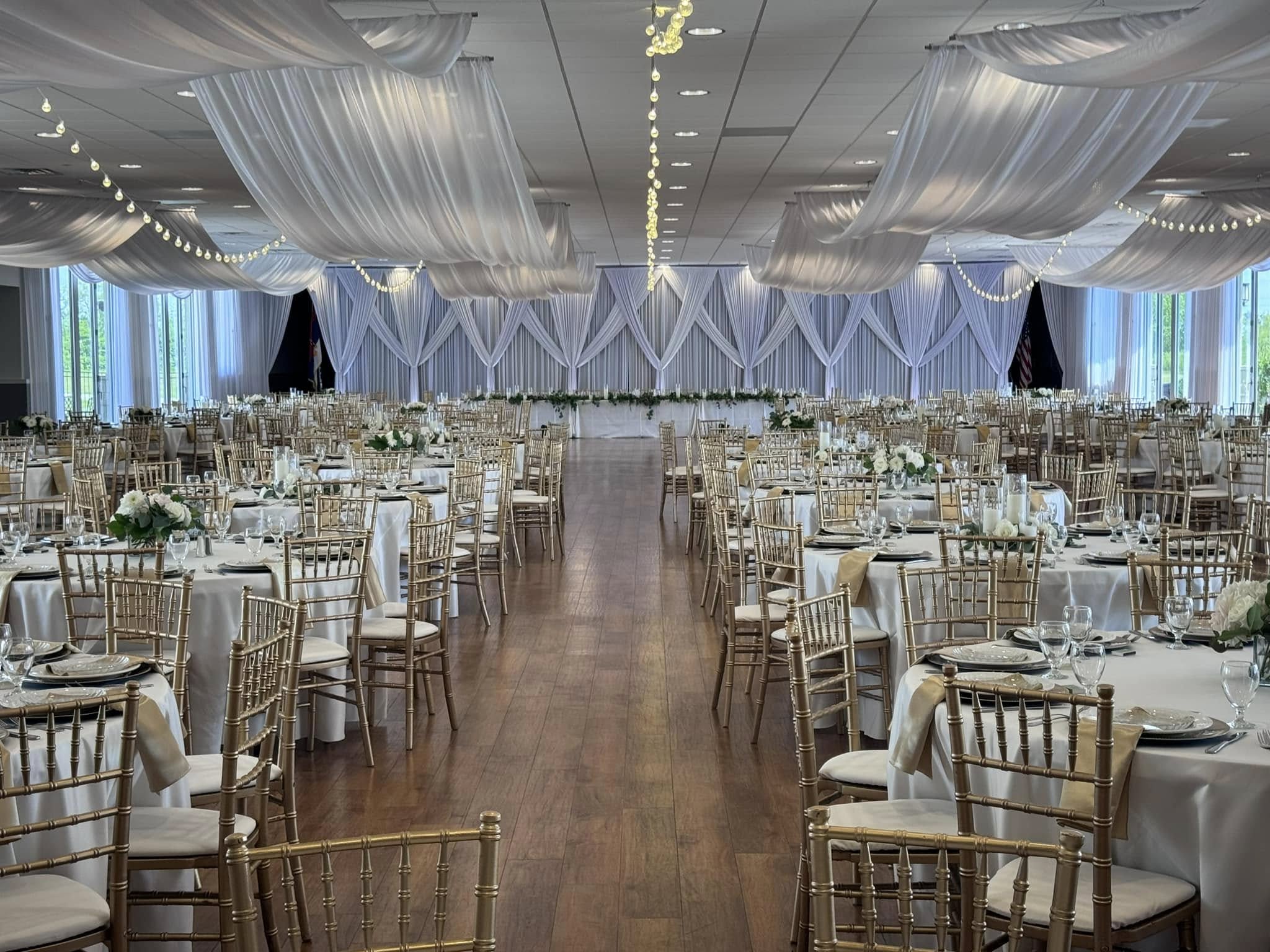 Banquets at St. Sava — wedding reception with dramatic ceiling drapery and string lights